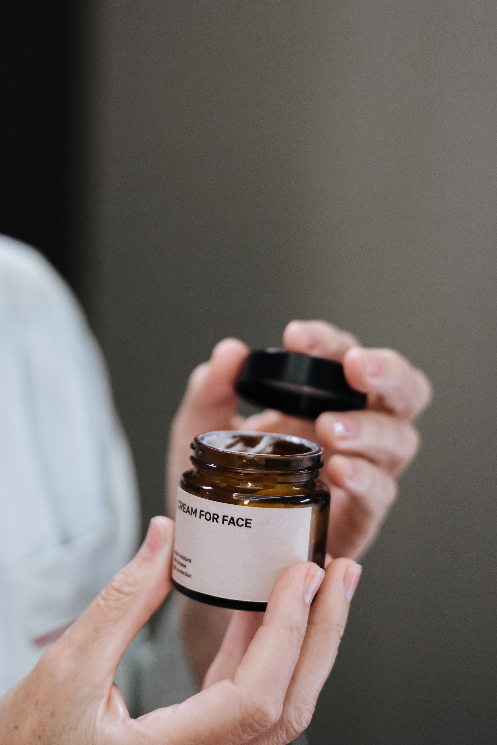 Jar of eye cream held in both hands