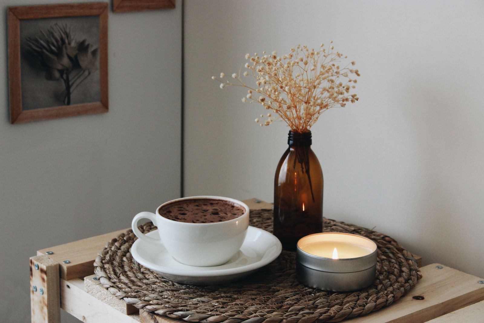 Candle with coffee and dried flowers in a warm interior