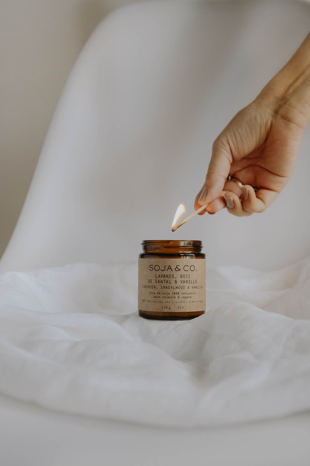 Lighting a soy wax candle with a matchstick