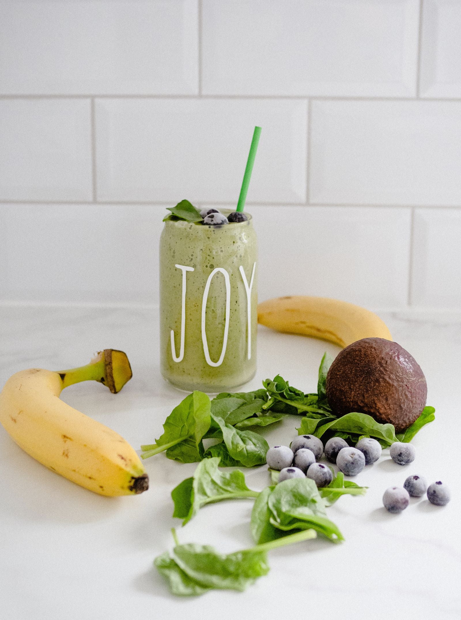 Green smoothie with banana, blueberries, and spinach ingredients
