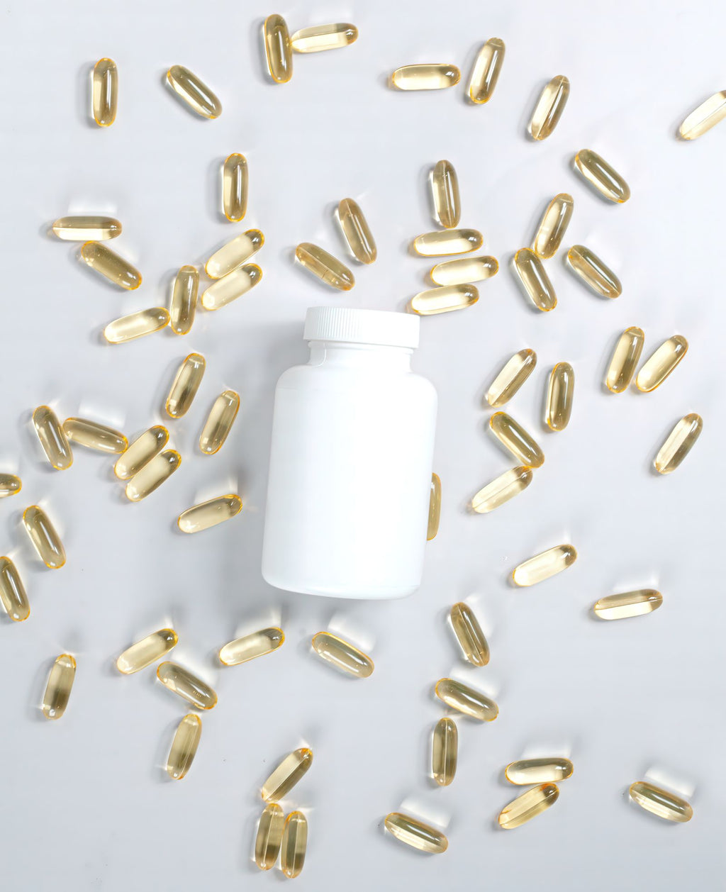 Supplement bottle surrounded by softgel capsules