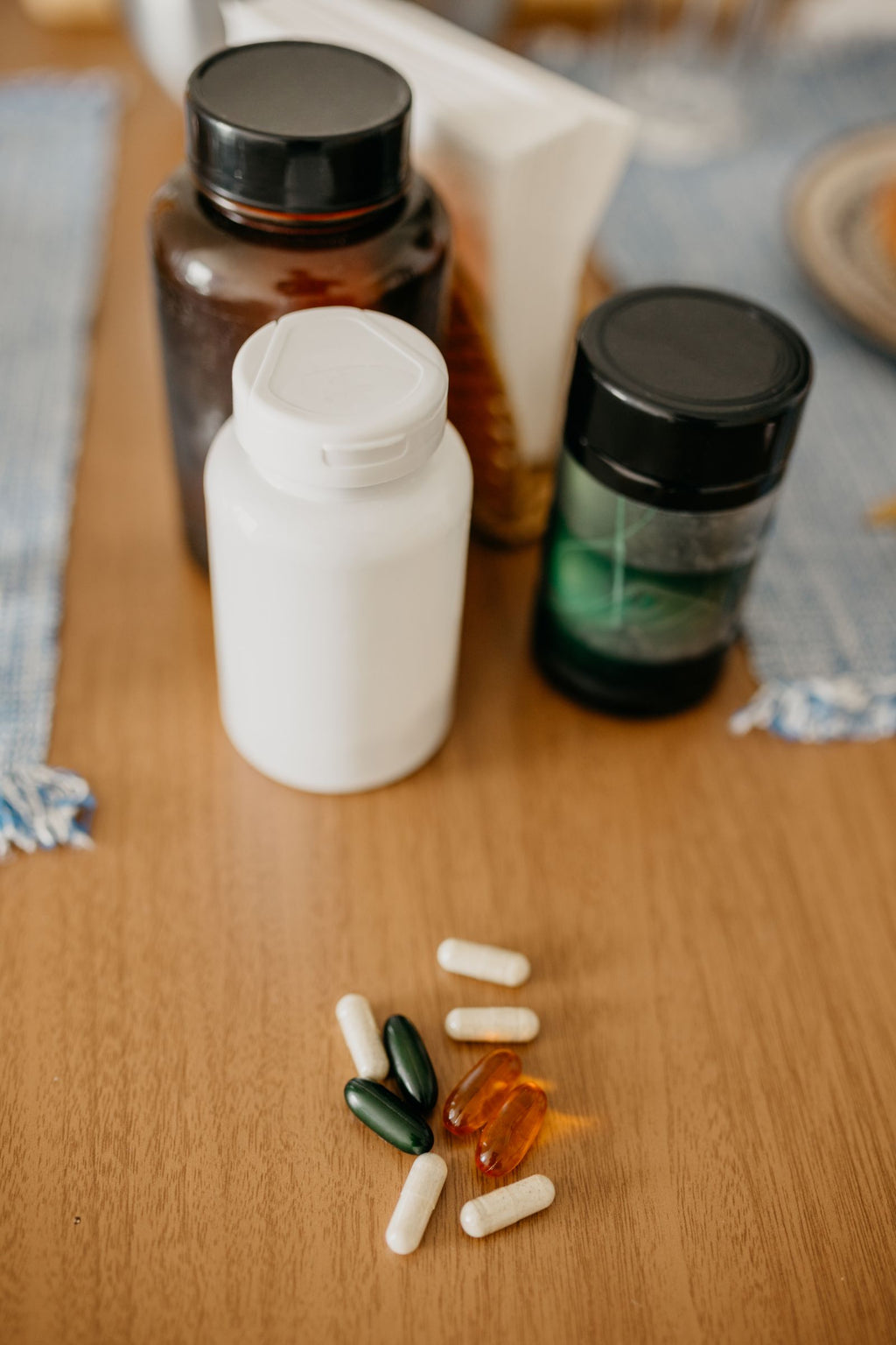 Supplement bottles and capsules on a wooden surface