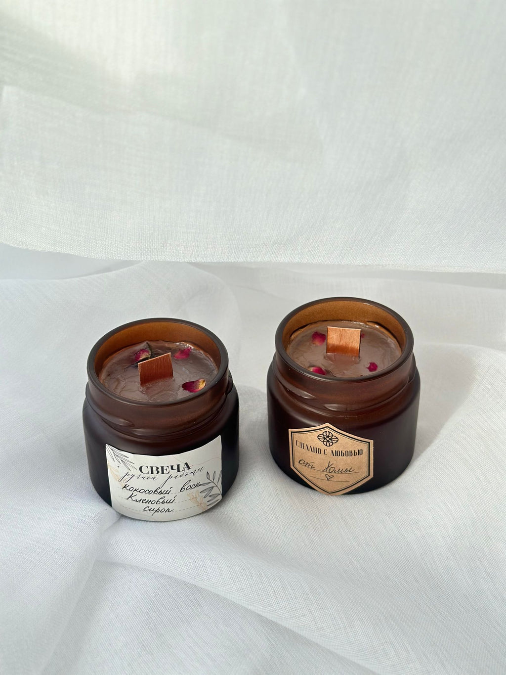 Artisanal candles in brown glass jars with wooden wicks