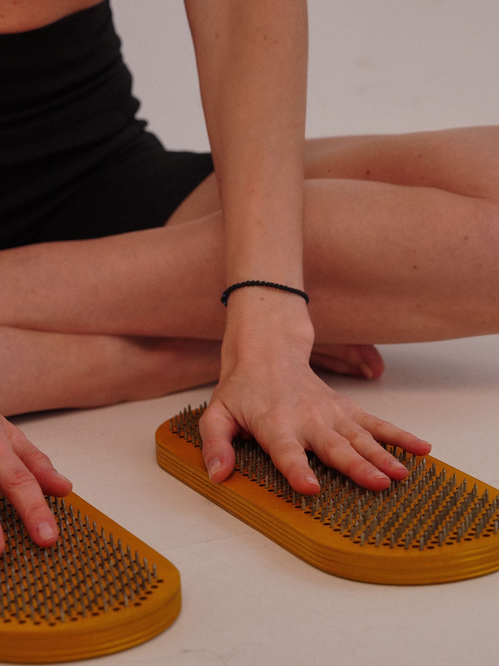 Woman relaxing on an acupressure mat in a studio