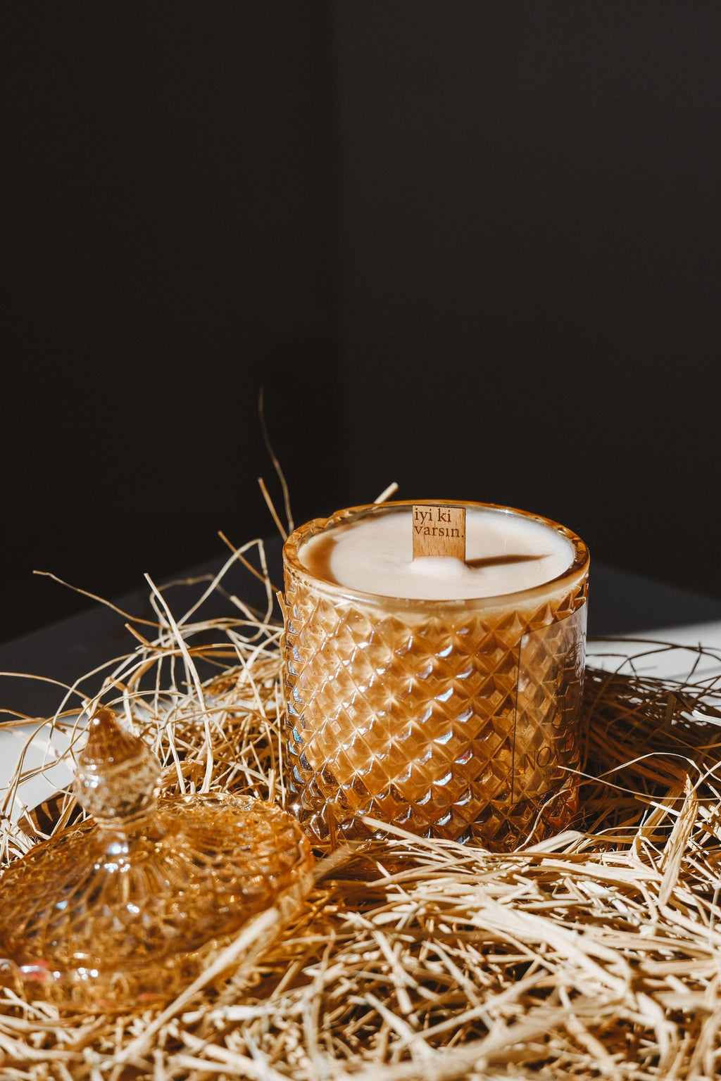 Decorative candle in a textured glass jar