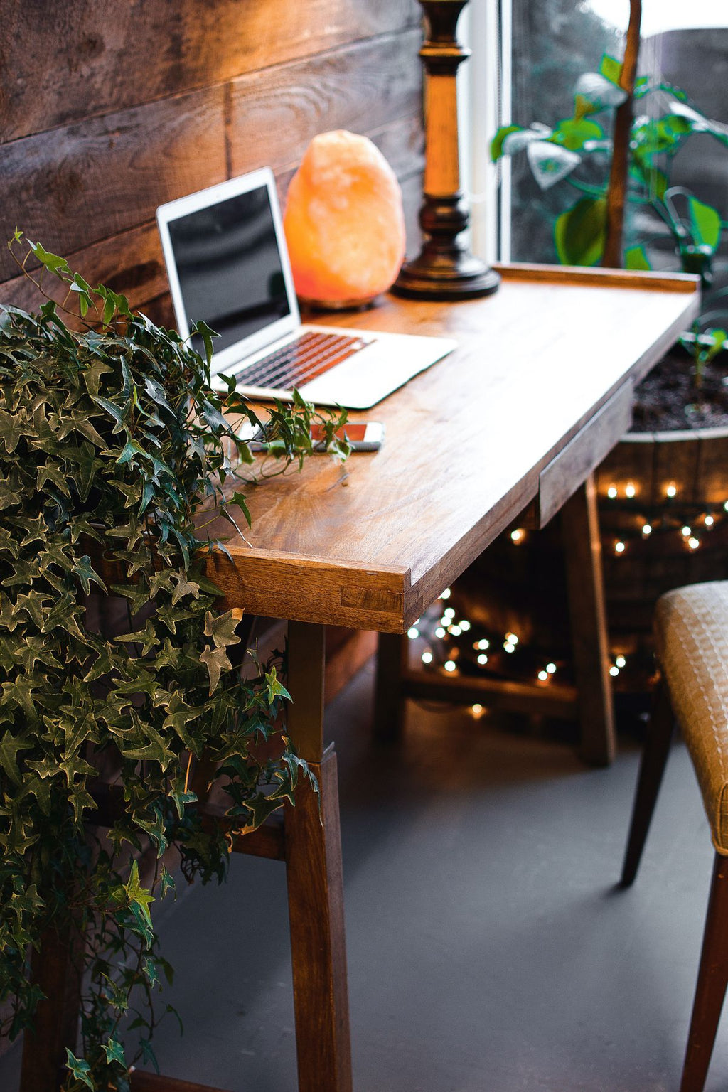 Himalayan salt lamp glowing warmly on a wooden desk