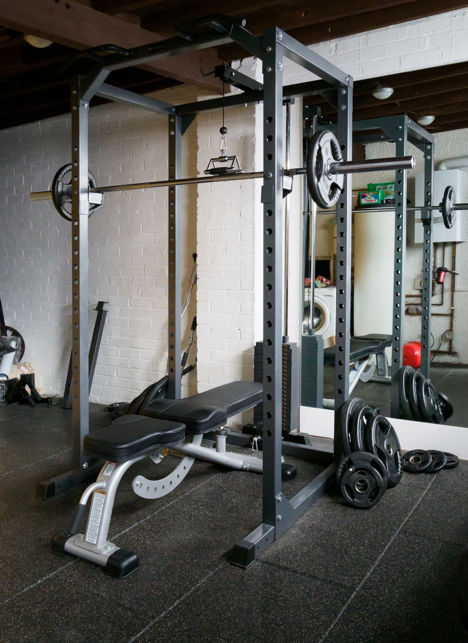 Home gym setup with weight bench and barbell