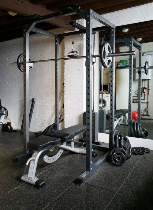 Home gym setup with weight bench and barbell