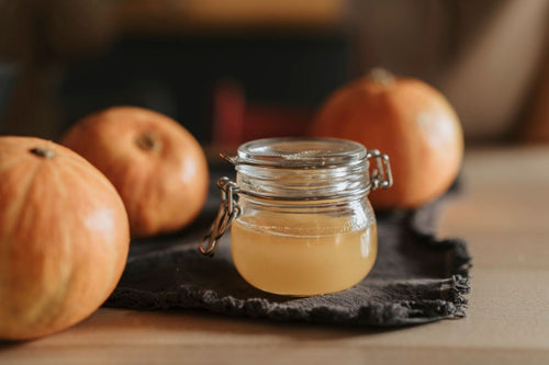 Apple cider vinegar in a glass jar with fresh apples