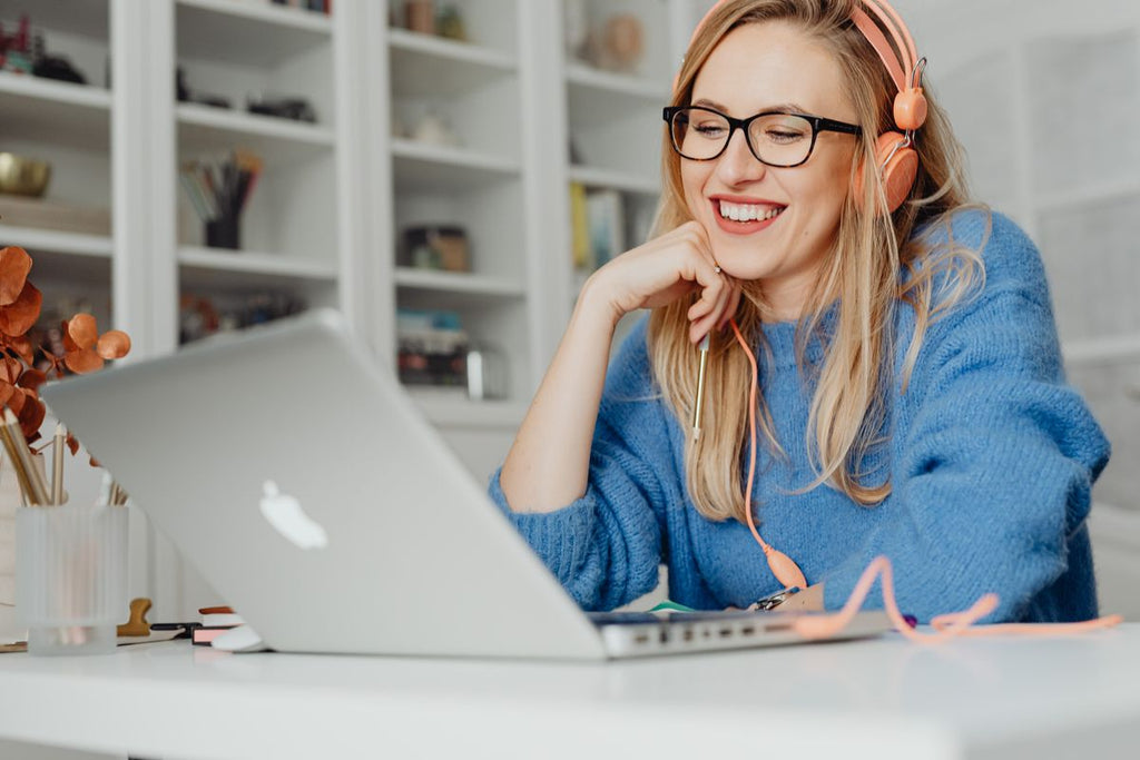 Woman wearing eyeglasses while working on a laptop
