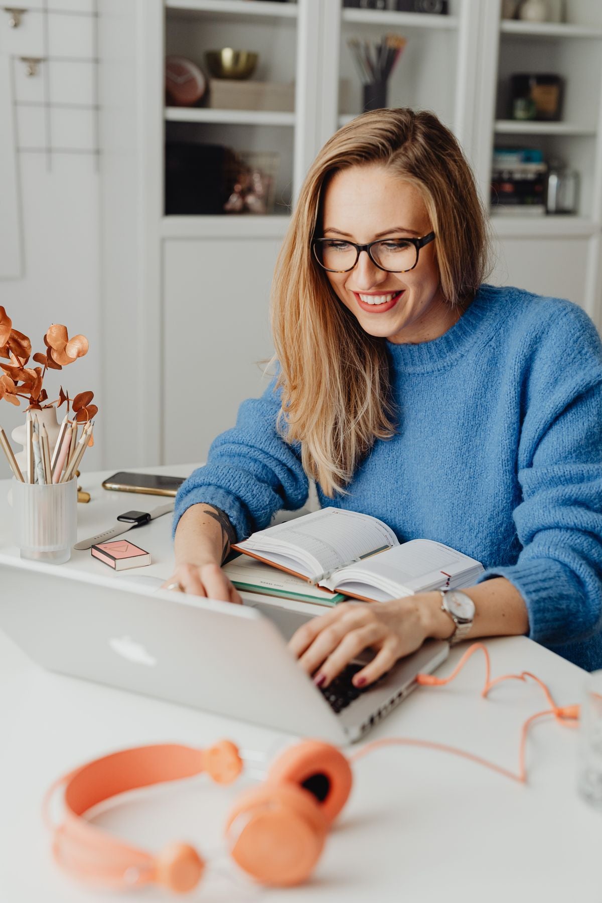 Woman in blue-light glasses using a laptop in the evening