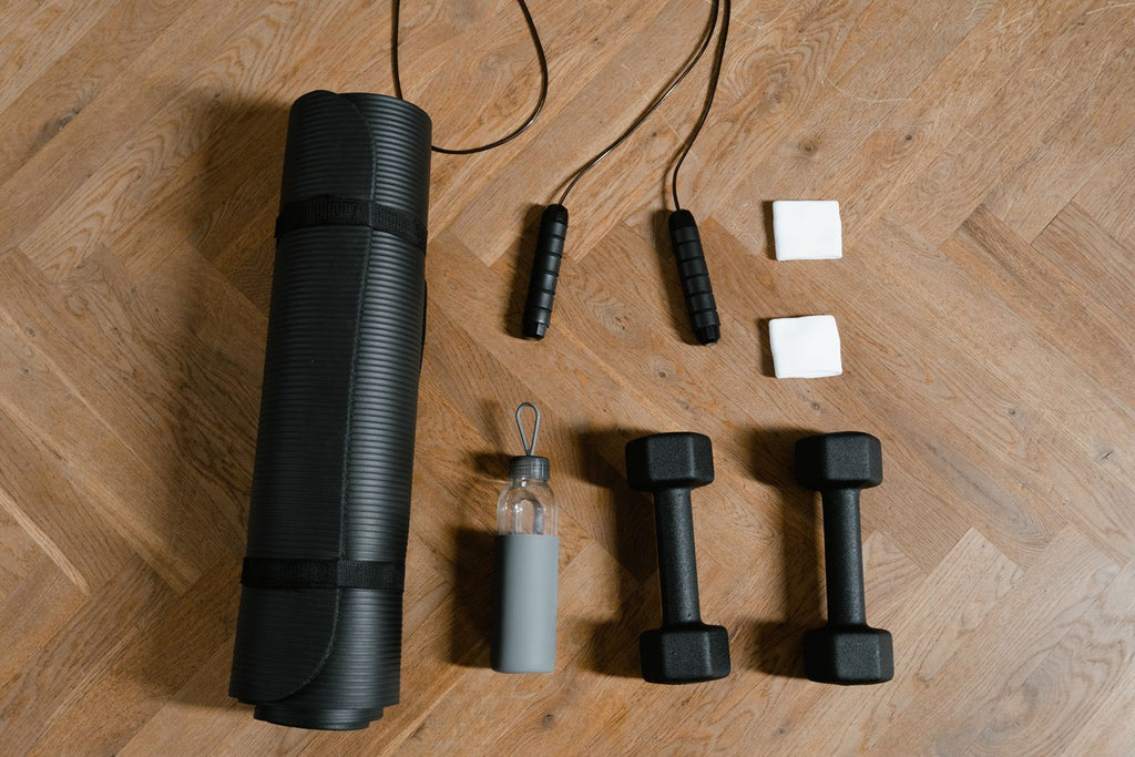 Workout essentials laid out on a wooden floor