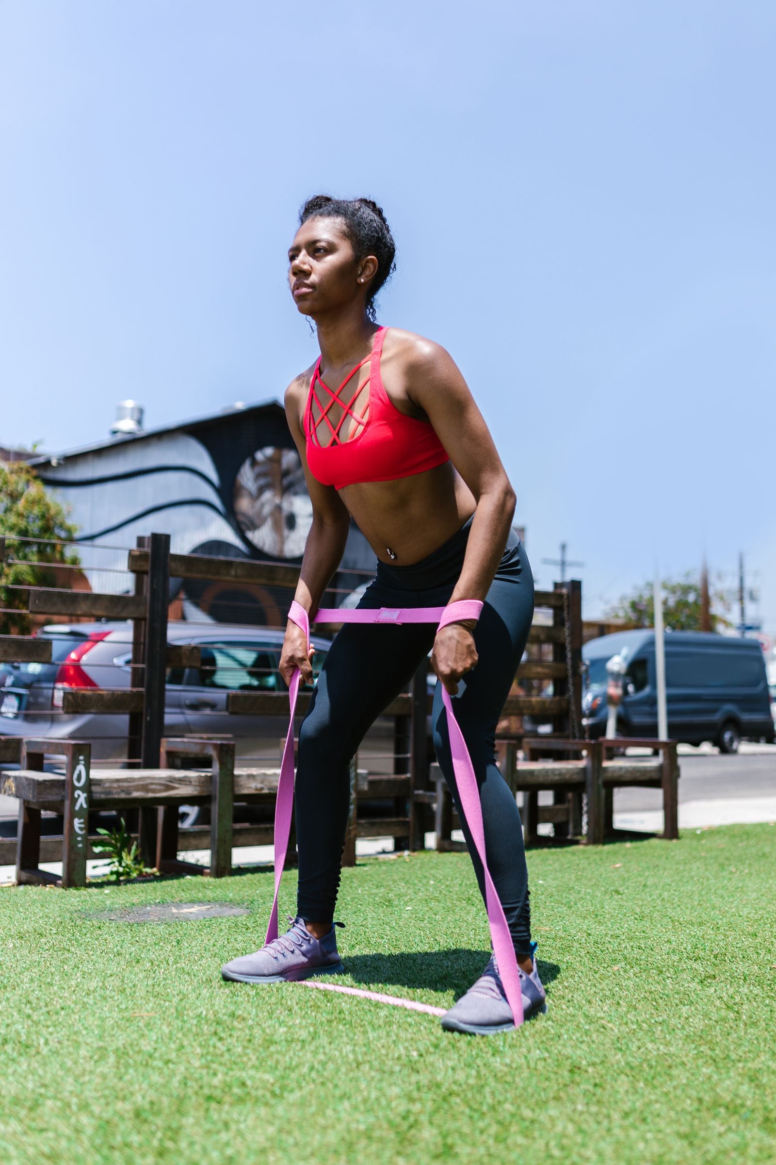 Woman in activewear training with resistance bands outdoors