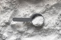 Collagen peptides white powder with measuring scoop