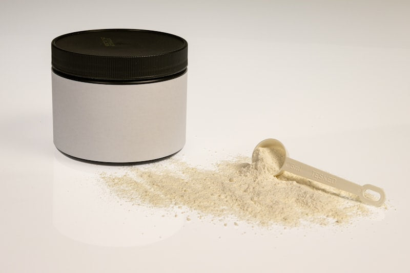 Whey protein powder jar with scoop